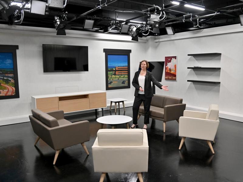 Jennifer Knapp, dean of SUNY Oswego's College of Communication, Media and the Arts, shows off a Hewitt Hall broadcast studio set to visitors just before the start of fall classes.