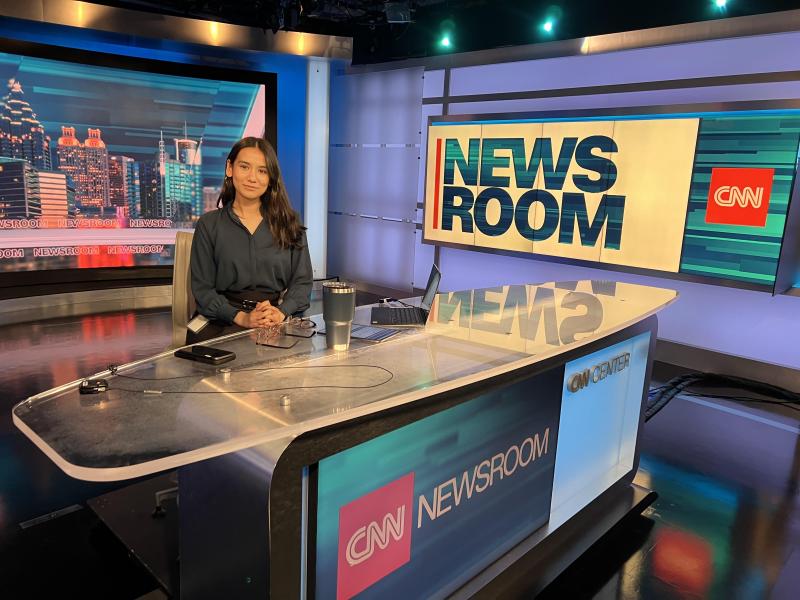 Oswego student Clarissa Karki sits at the CNN news desk at the CNN headquarters in Atlanta.