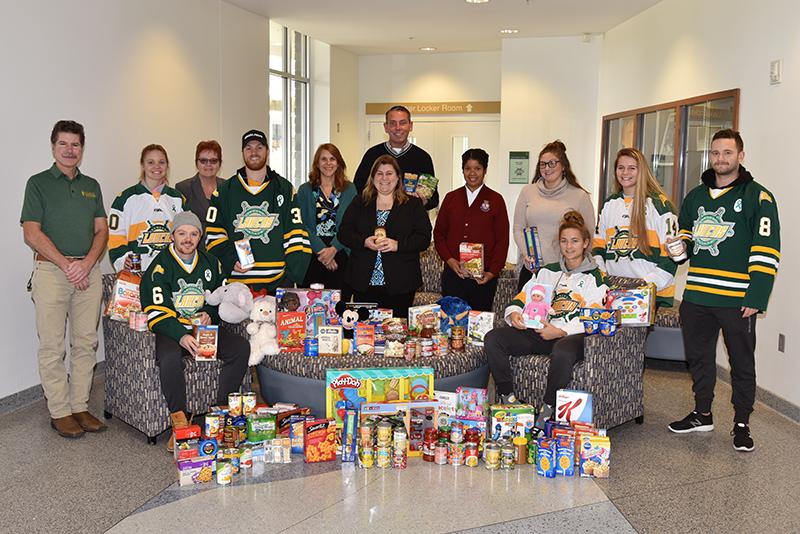 Hockey teams with collected toys and other donations