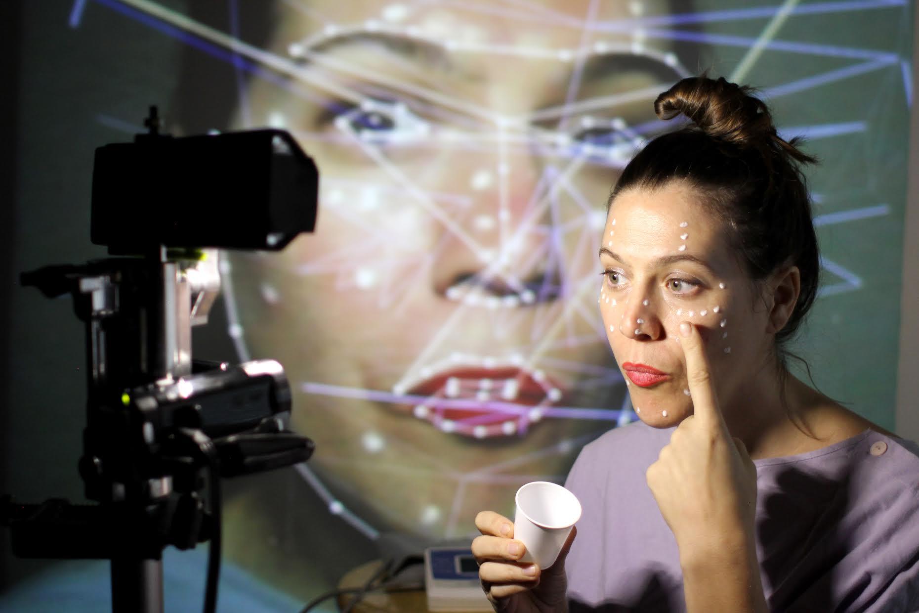 Mutlimedia performer Anna Oxygen works with eye tracking software in building a 3D creation