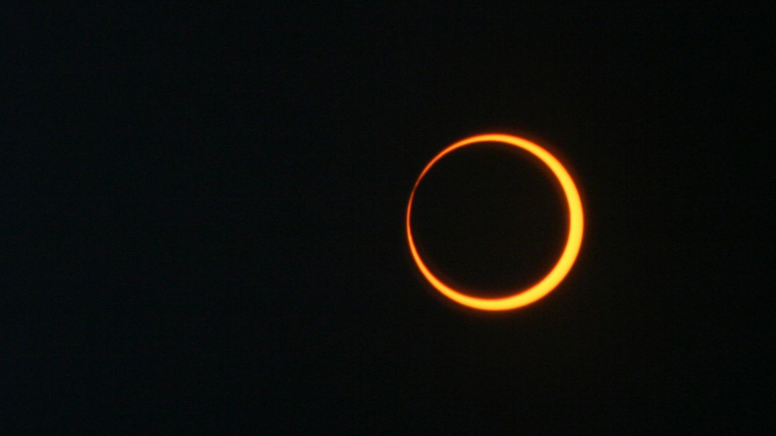 Image of an annular solar eclipse, where the moon moves over the center of the sun to create a ring of fire appearance