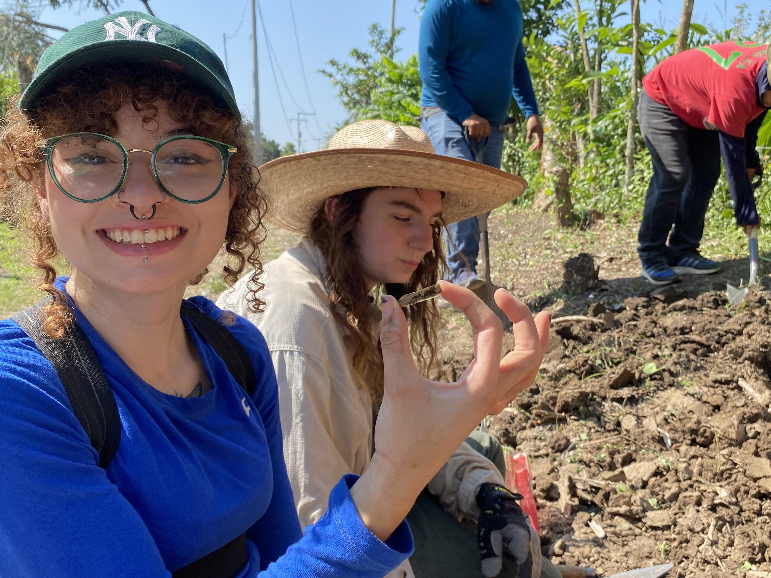 Anthropology major Jylene Figueroa holds up a discovery from a dig earlier this year in Veracruz, Mexico, as part of a National Science Foundation funded research project