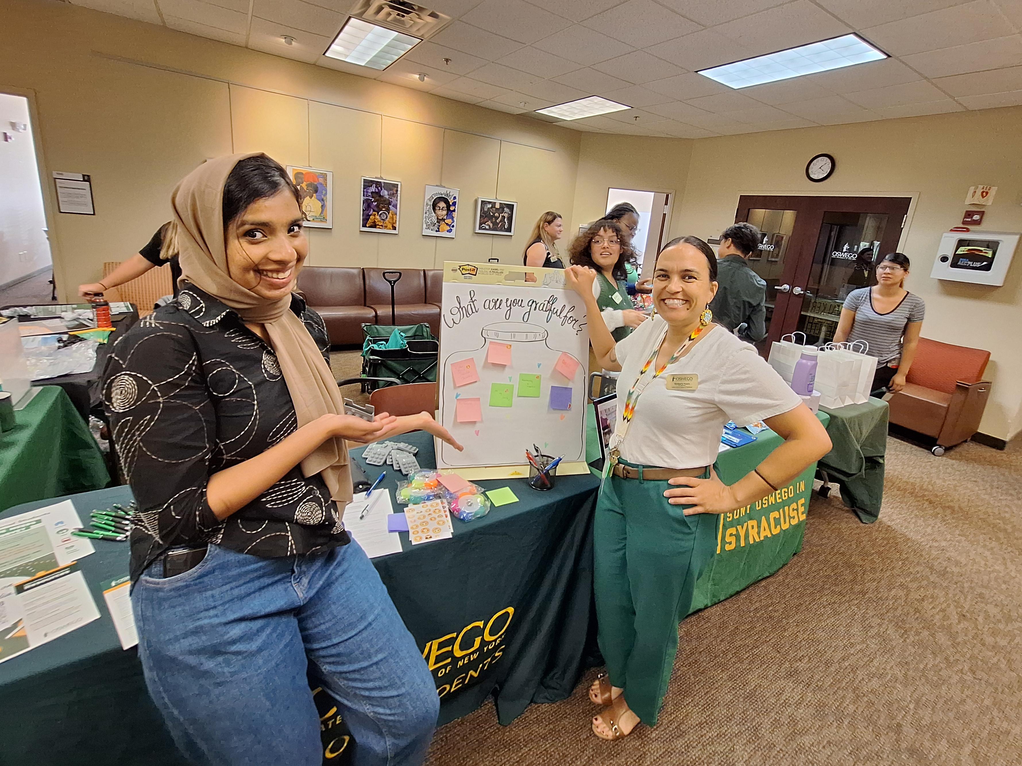 Shown at an outreach event at SUNY Oswego's Syracuse Campus in the fall are Office of the Dean of Students representatives, from left, graduate assistant Sumayya Sagheer; Kimberly Fuqua, university homeless liaison; and April Lopez, coordinator of SHOP