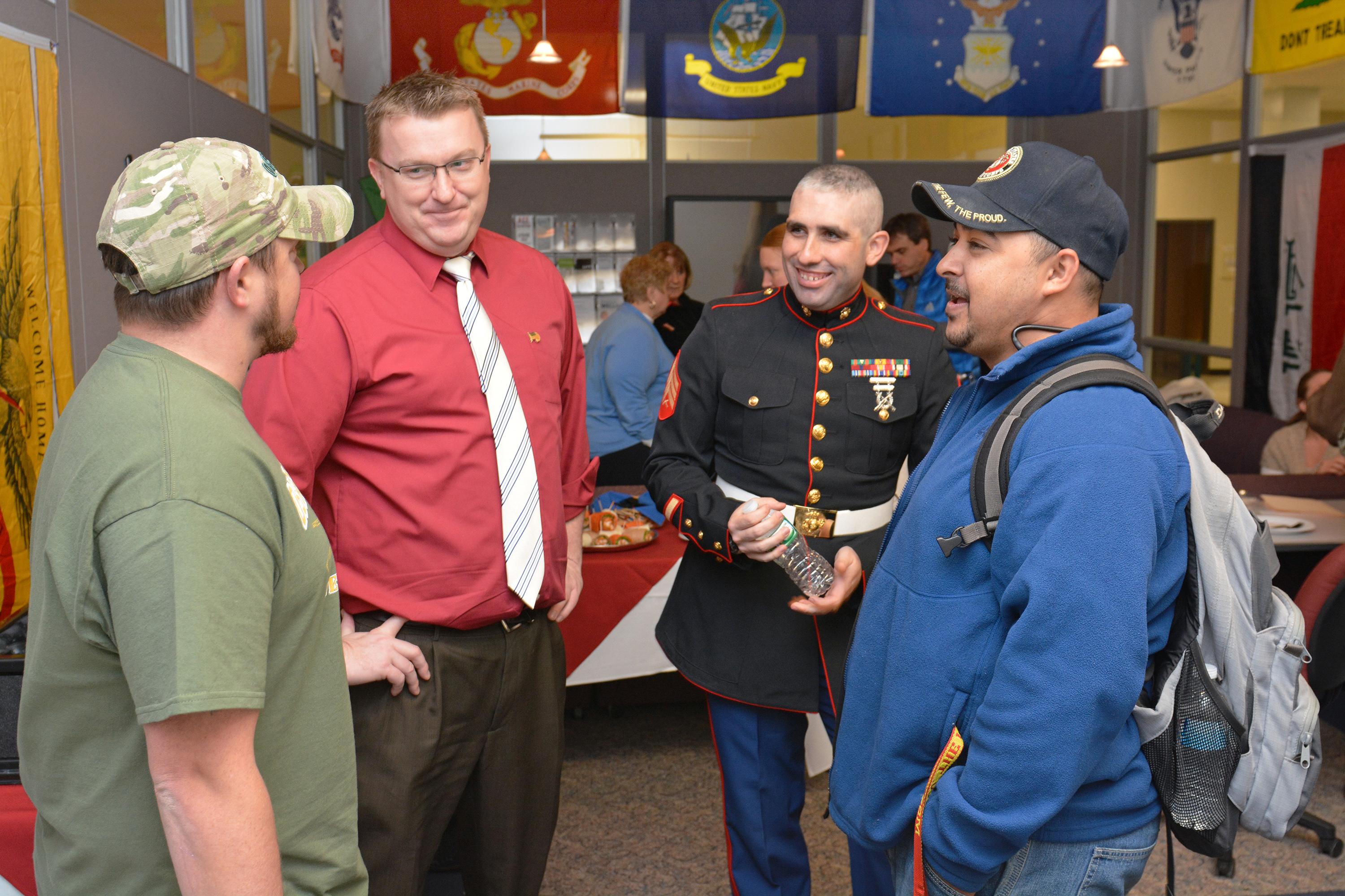 Ben Parker (second from left), coordinator of veteran and military services, speaks with student veterans at a Veterans Day open house. 