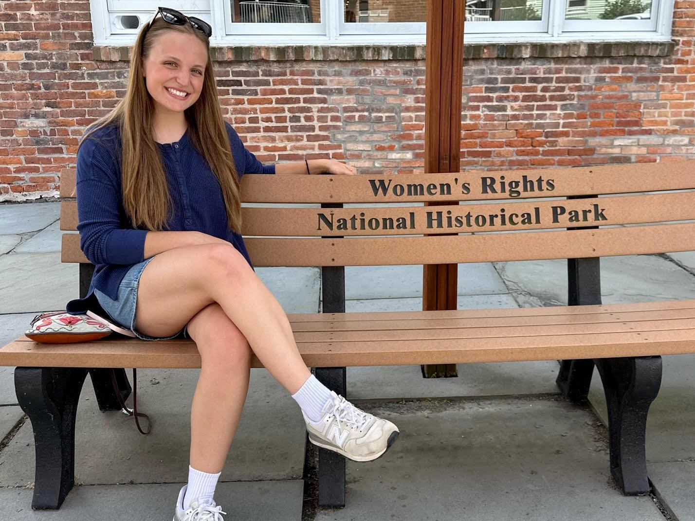Carolyn Adams sitting on a bench at the Women's Rights National Historic Park 