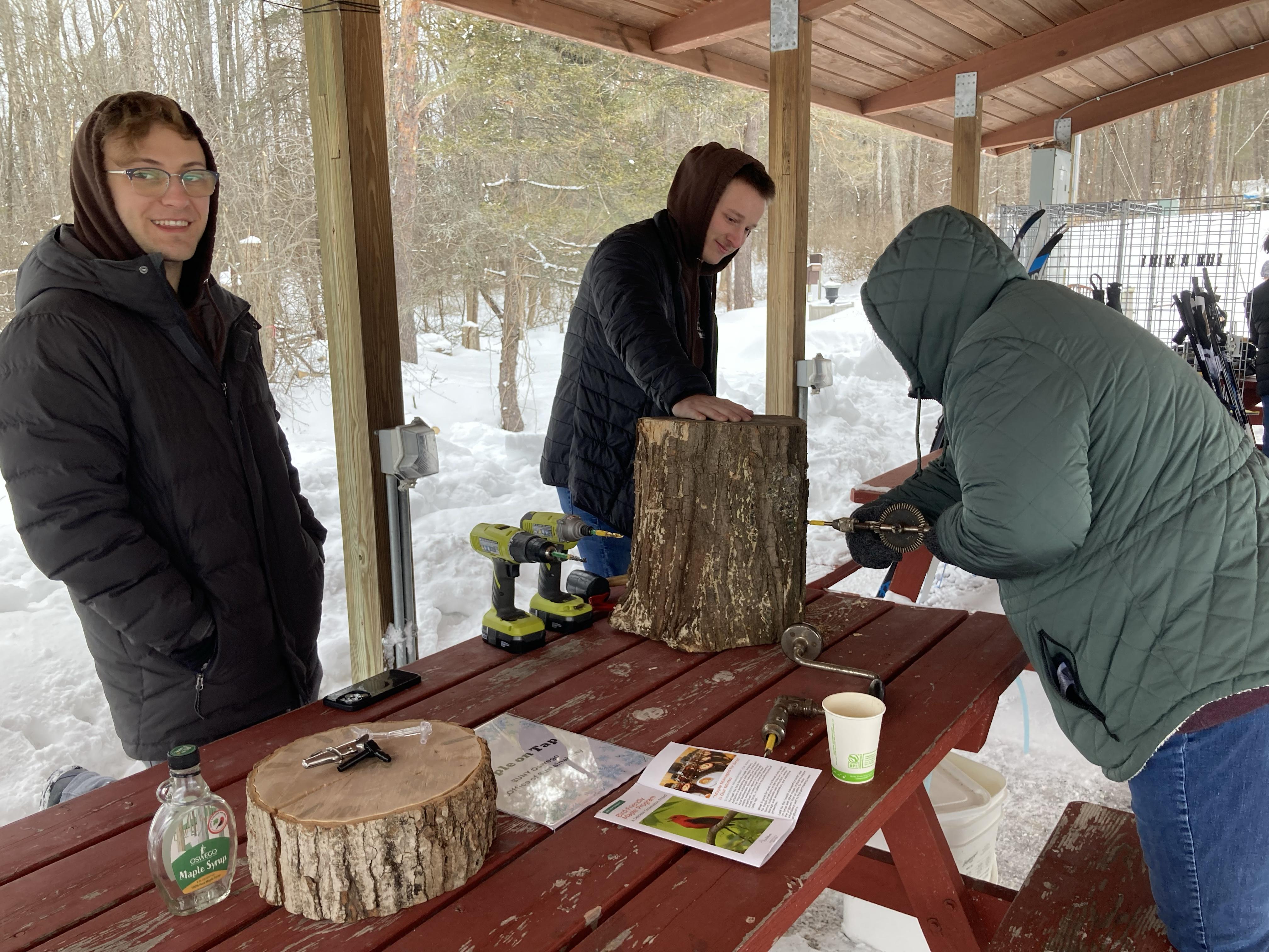 Students show how to drill for sap