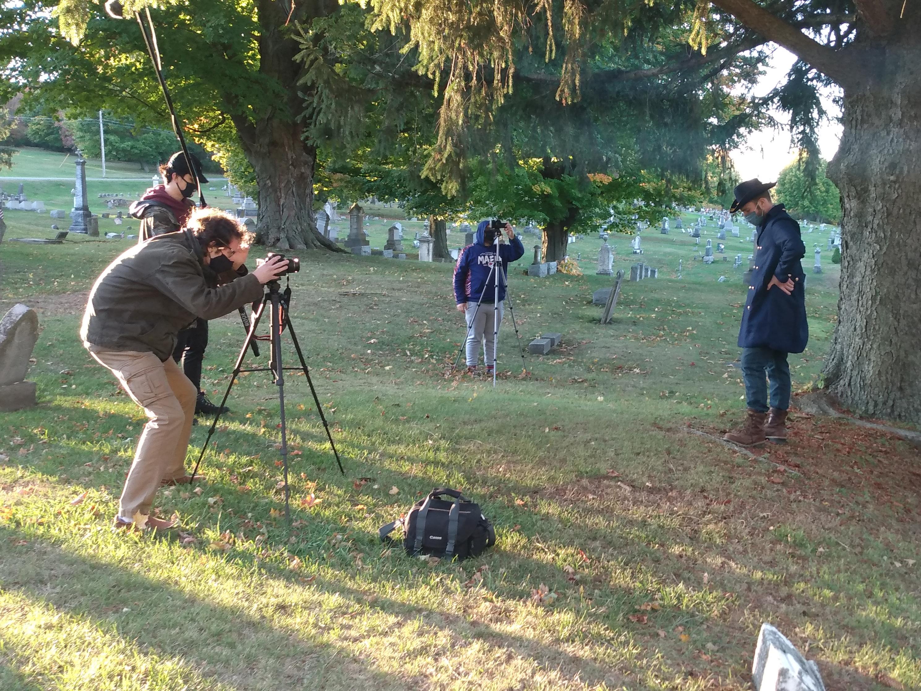 Students acting and filming cemetery storytelling
