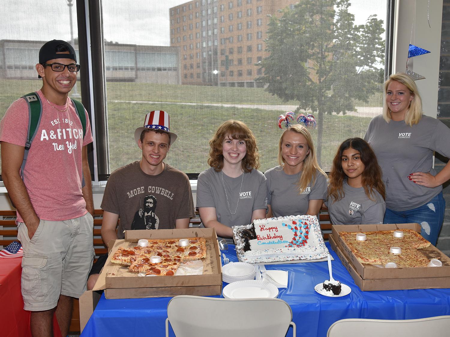Students with pizza and cake at Constitution Day party in 2018
