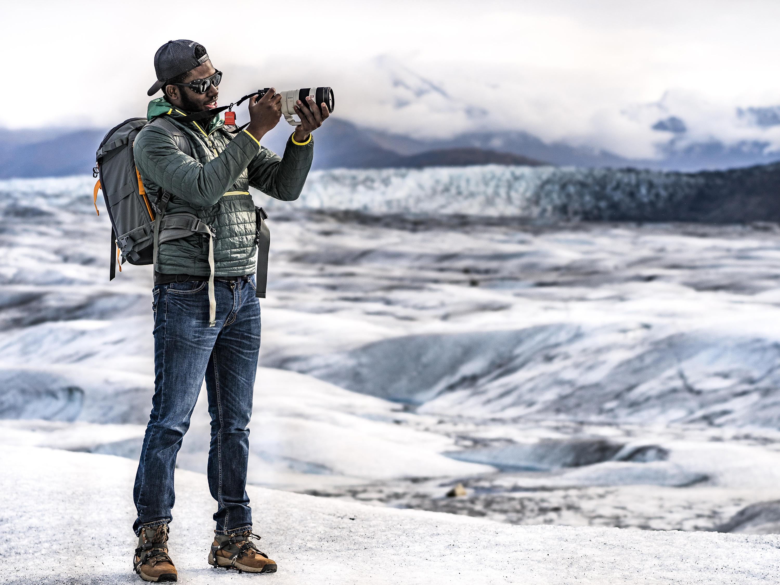 Mic-Anthony Hay takes photographs on a glacier in Alaska