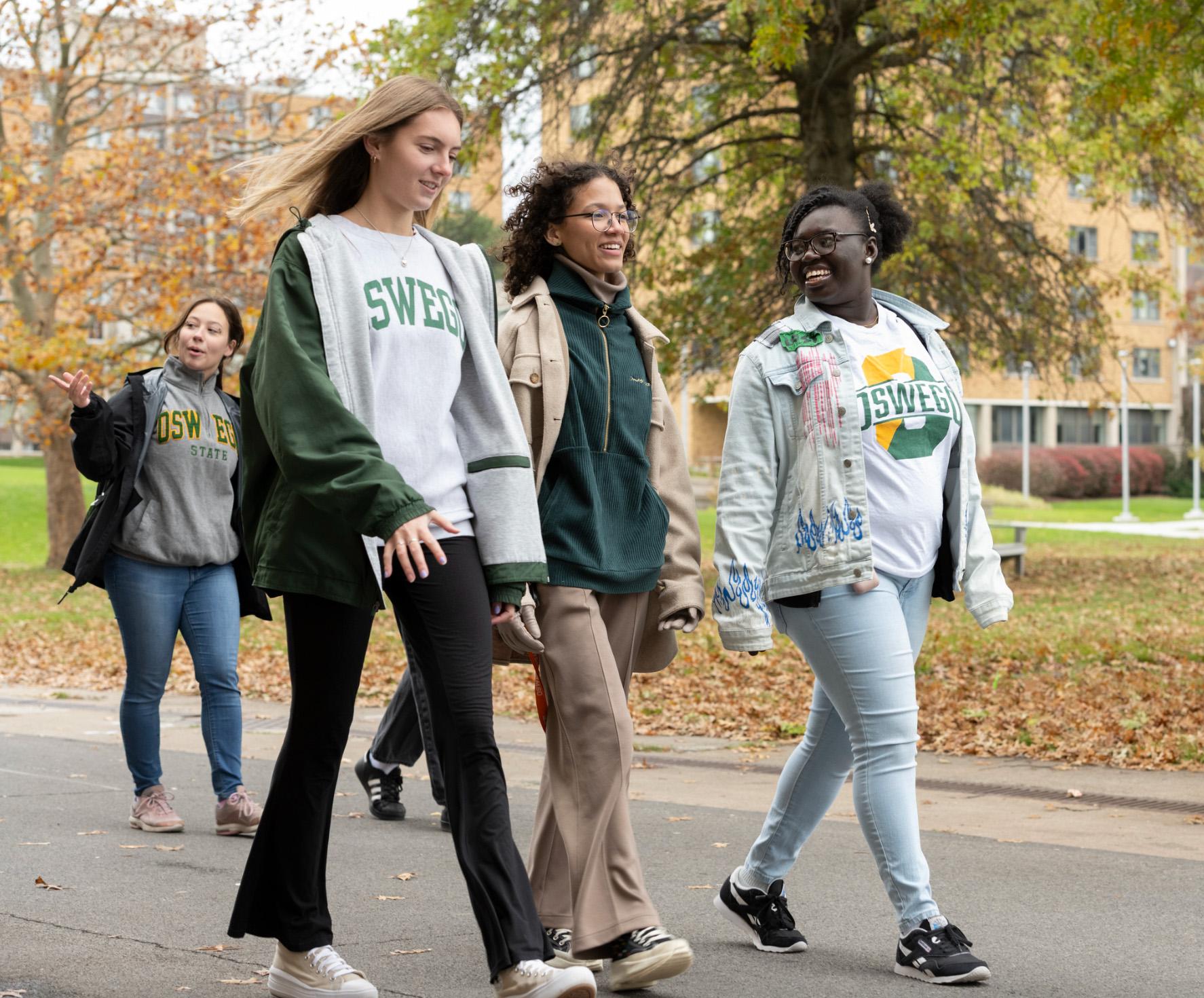 Students walk across campus on a fall day