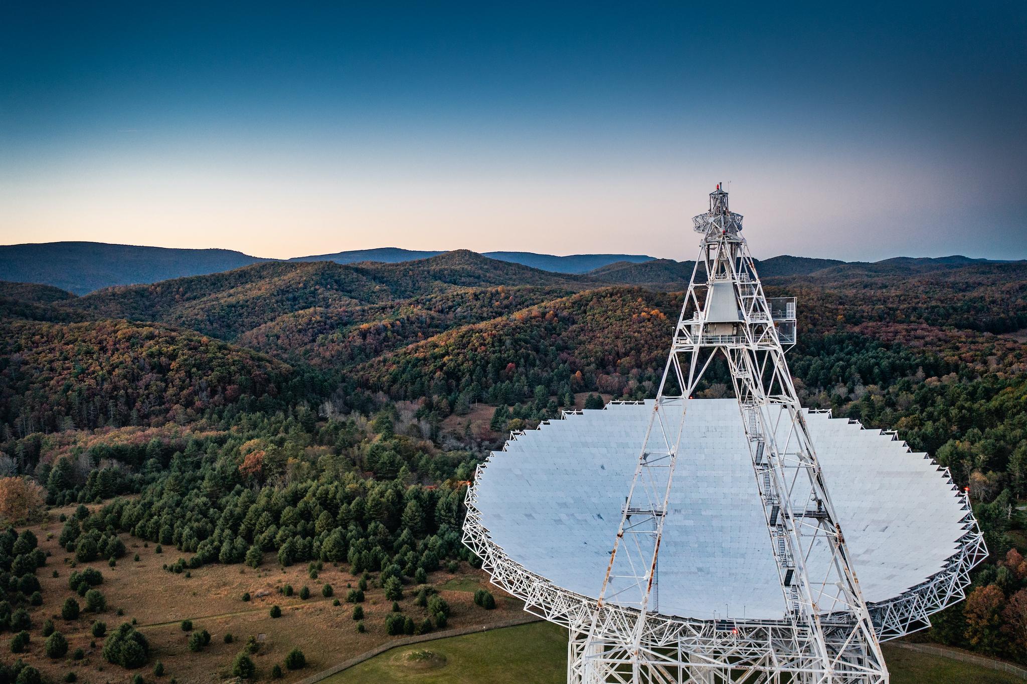 The massive Green Bank Telescope points to the sky, picking up observations in part of a cosmic puzzle researchers try to solve