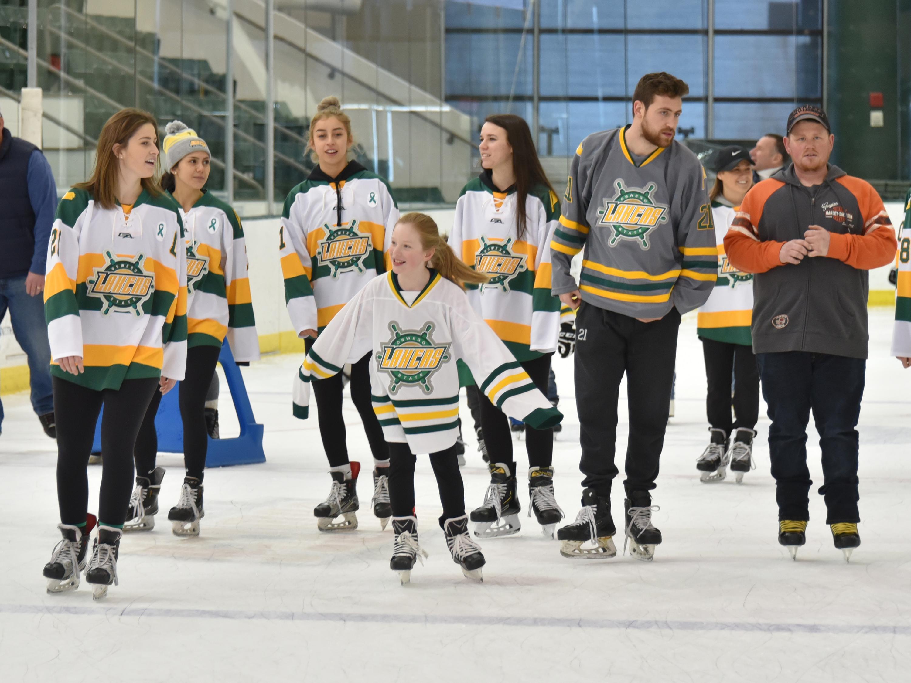 Laker hockey players skate with children