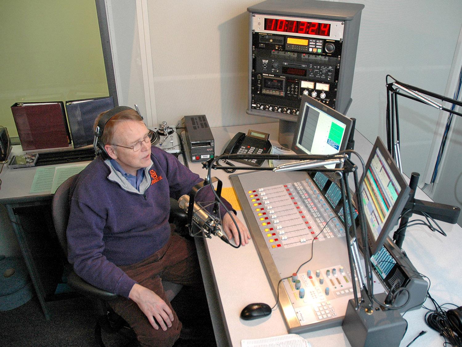 File photo of John Hurlbutt broadcasting from WRVO studios