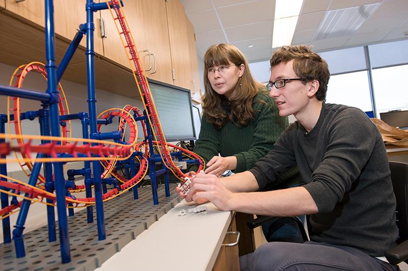 Professor Carolina Ilie and student working on physics of rollercoasters project