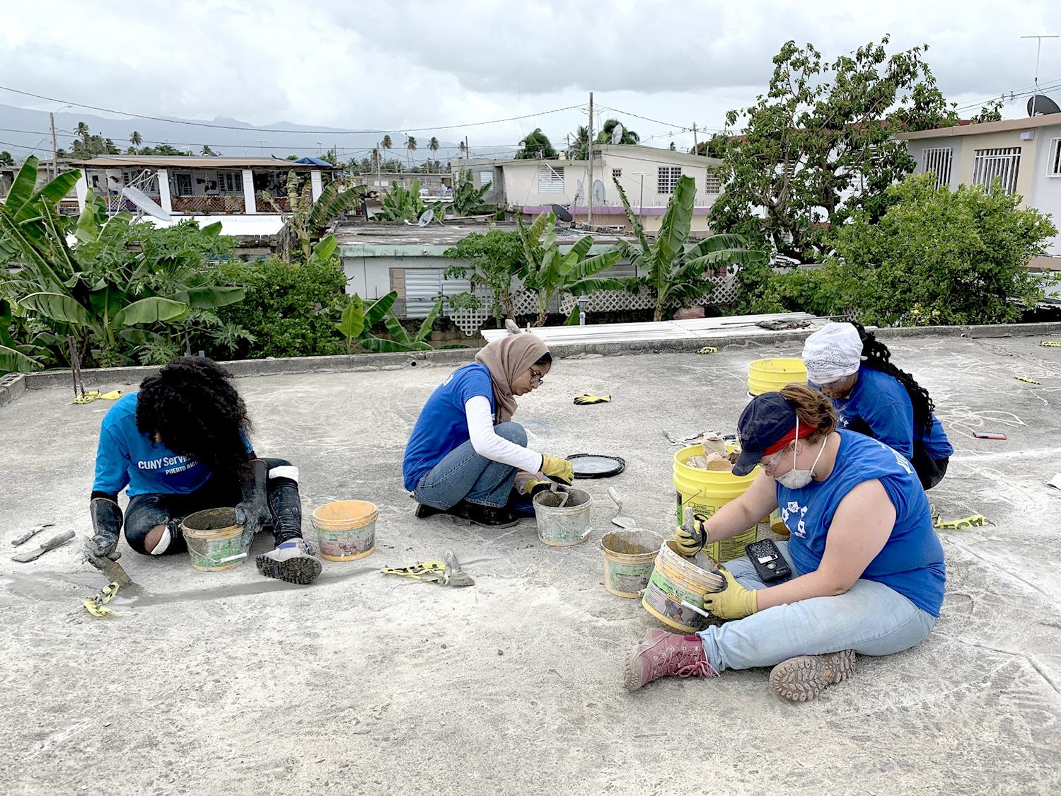 Students work on patching a roof in Puerto Rico