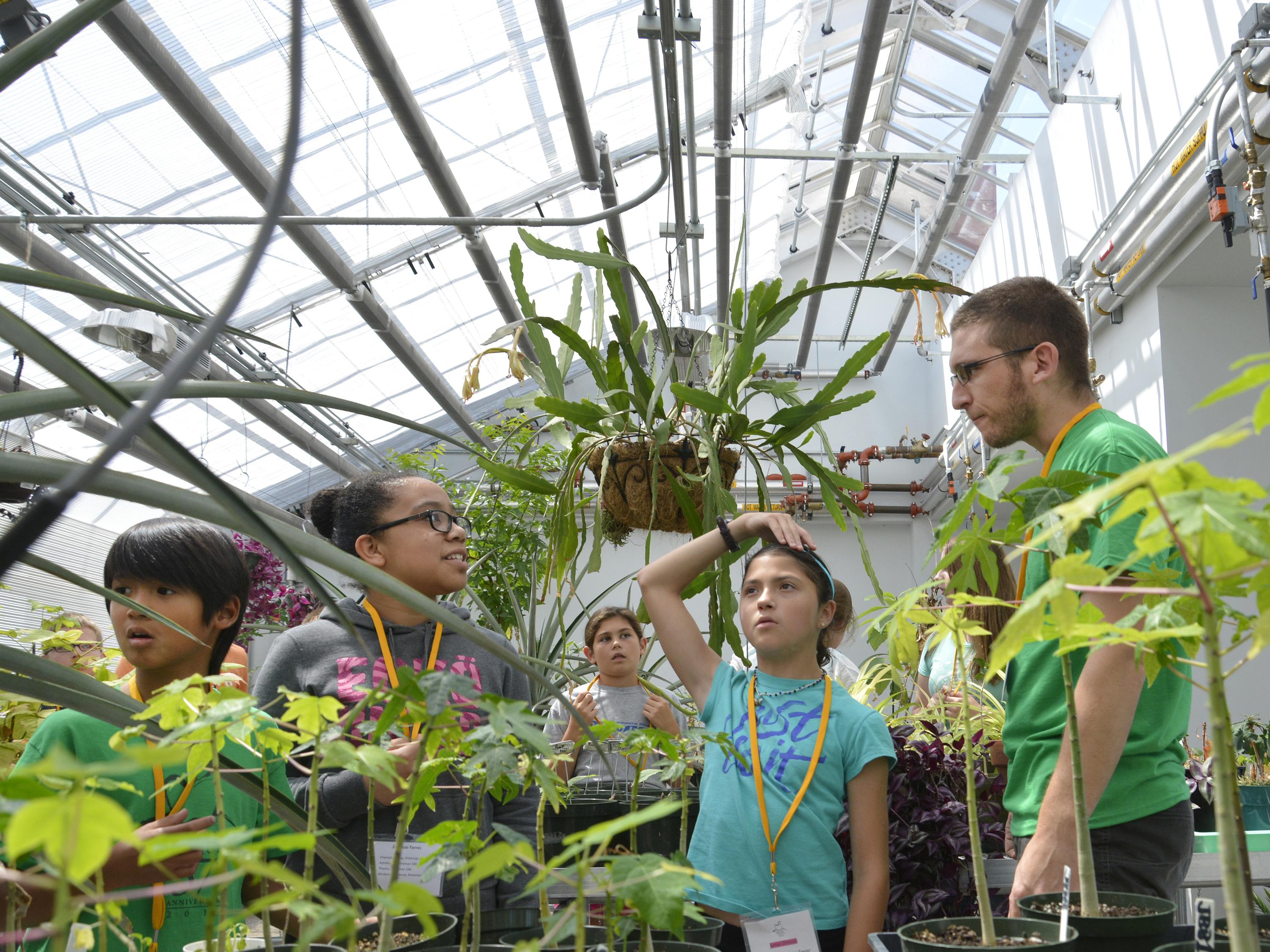 Children at the Sheldon Institute explore the greenhouse atop the Richard S. Shineman Center.