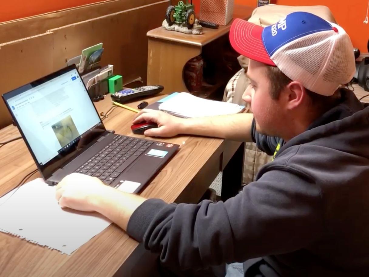 Corey Sykes demonstrates a home work station in a video about avoiding distractions