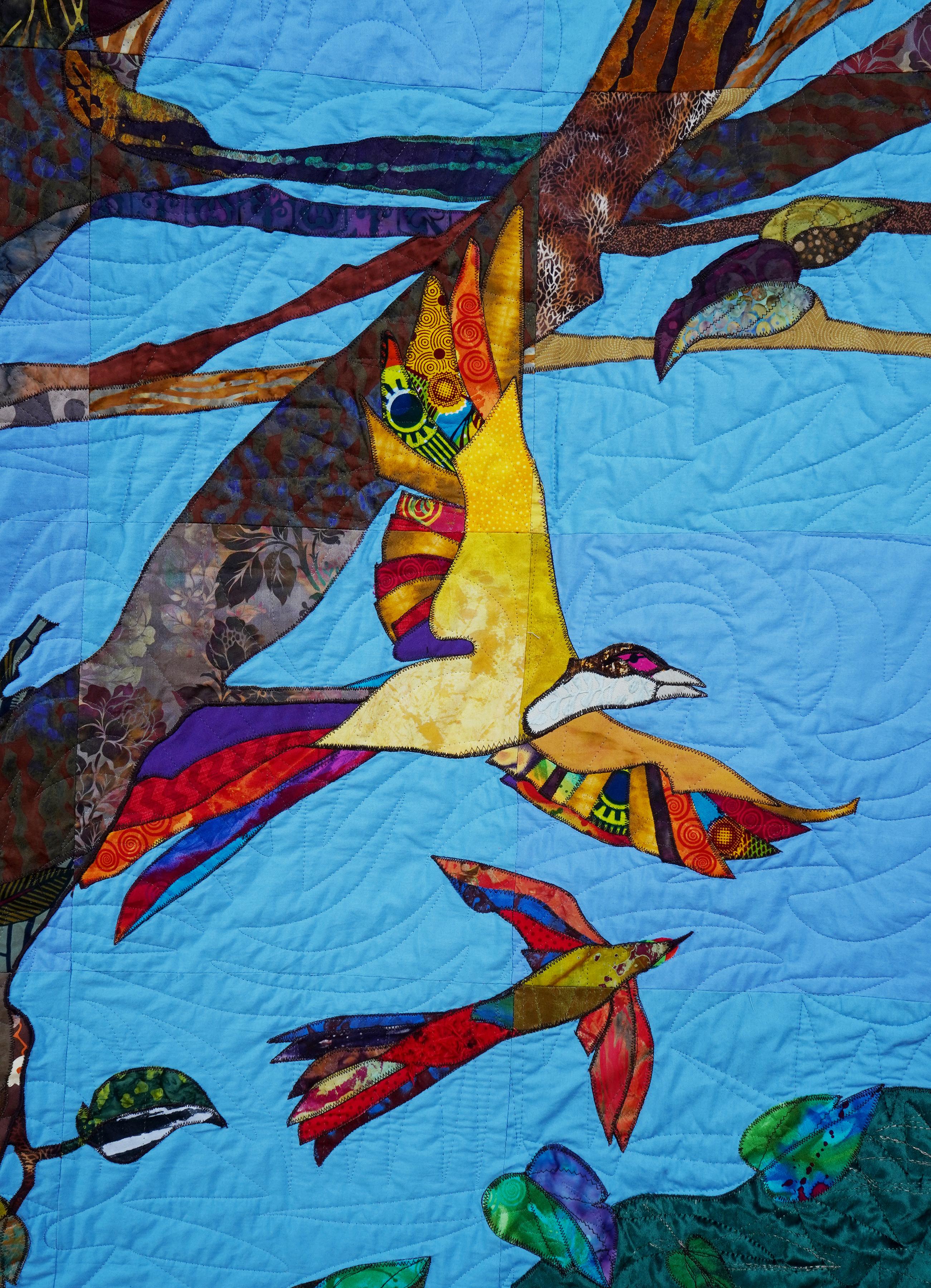 A multicolor community-created quilt that uses birds as a metaphor for the Black experience in America
