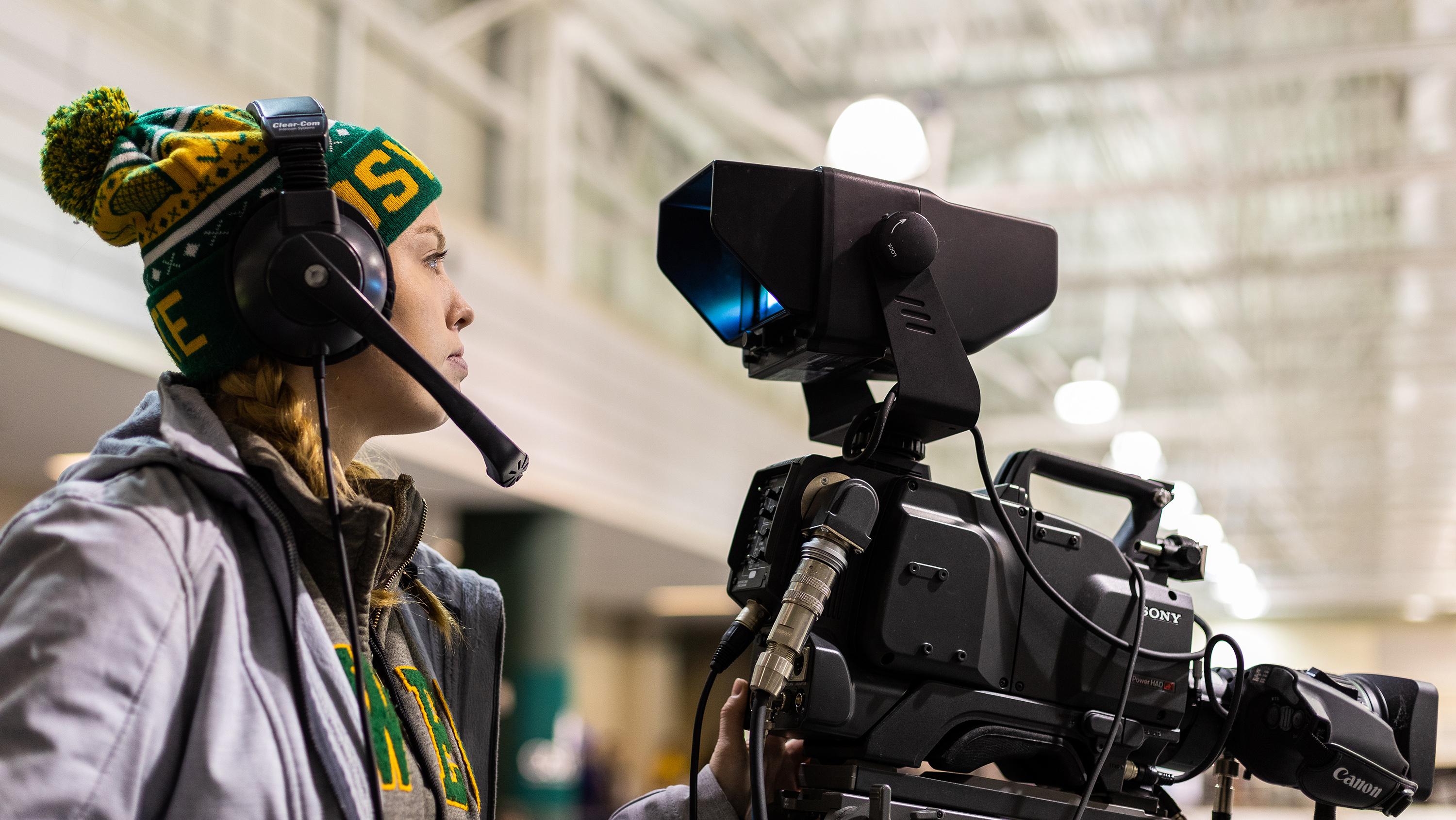 Tara O'Donovan operates a camera at an Oswego hockey game