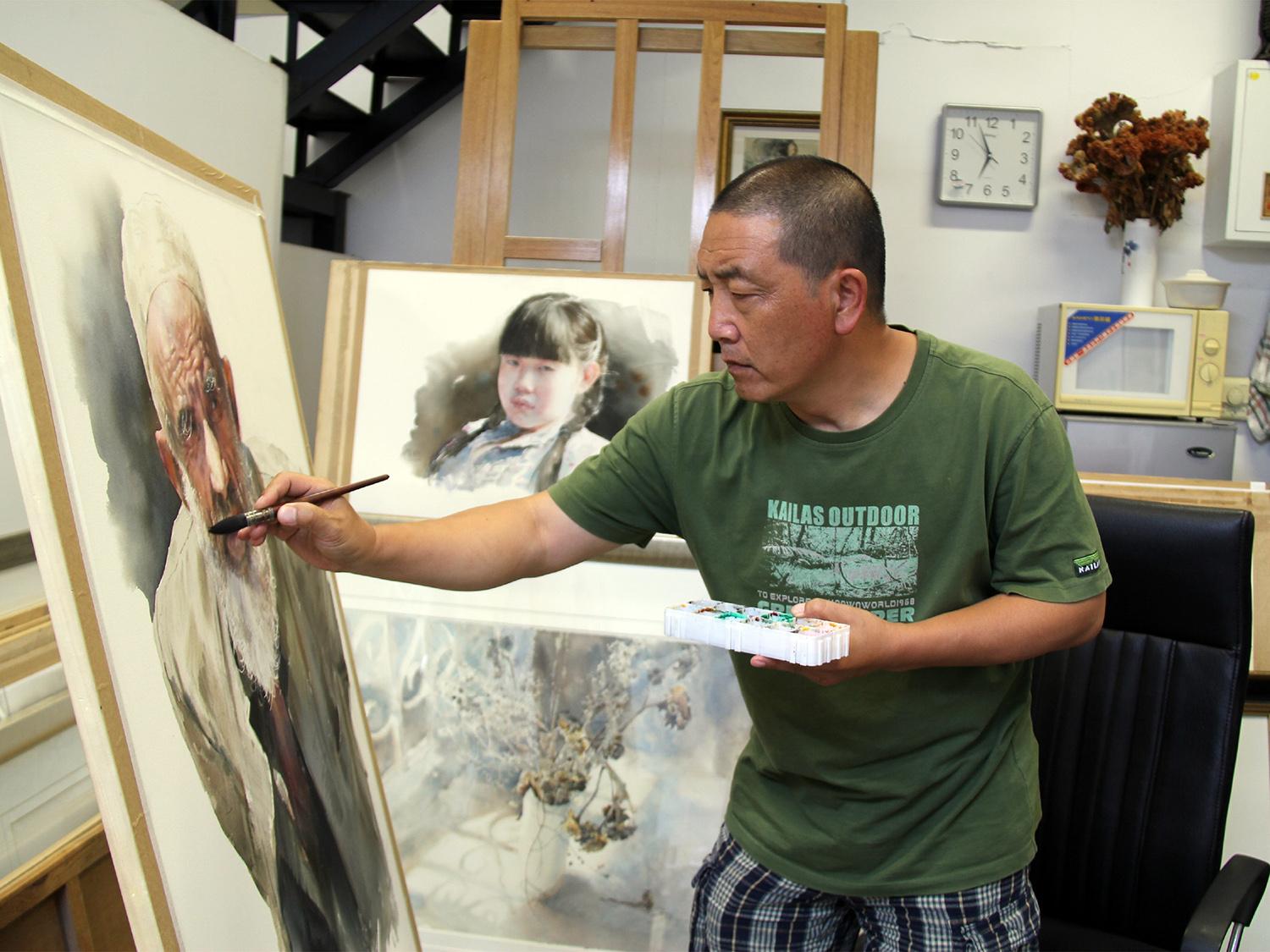 Artist Zhinan Jiang works on a watercolor painting