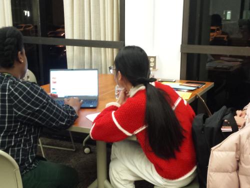 Michelle Bishop of Penfield Library works with students in this image from fall 2019