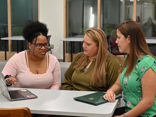 Gabriella Patterson, a double major in wellness management and psychology, works on her Quest project with health promotion and wellness faculty members and mentors Jessica Harris and Elizabeth Kieda  