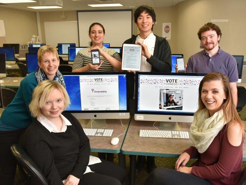 Students and faculty show off the Vote Oswego site they designed which won a national accessibility award