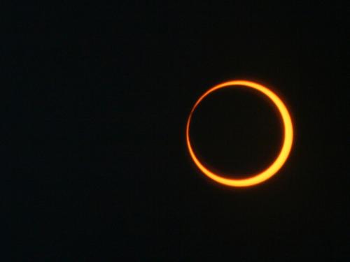 Image of an annular solar eclipse, where the moon moves over the center of the sun to create a ring of fire appearance
