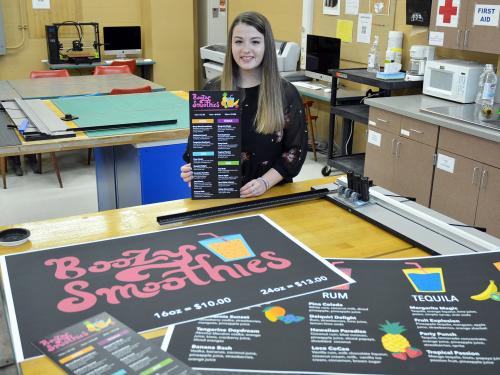 Art student Julie Farquhar poses with pieces from her portfolio