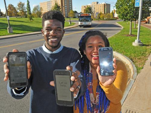 Students show BusShare web app on their smartphones