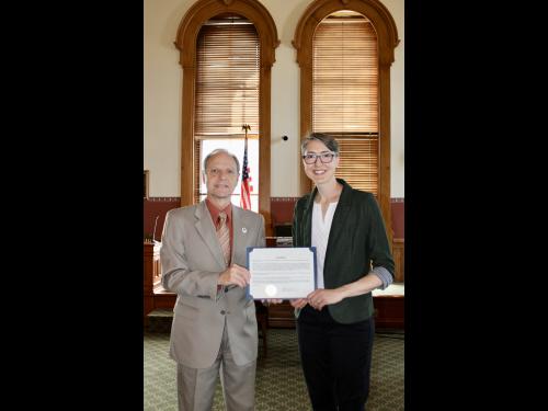 City of Oswego Mayor Robert Corradino shares a proclamation to honor the "One City. One Campus. One Community." photojournalism project with SUNY Oswego Assistant Vice President of Workforce Innovation and External Relations Kristi Eck 
