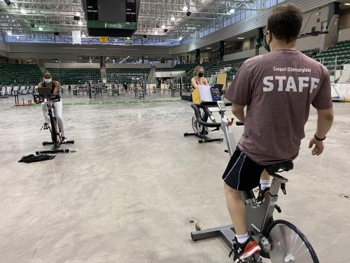 Students participate in an Indoor Cycling group workout