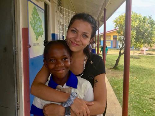 Isabella Falcigno hugs a Jamaican youth