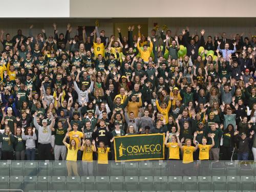 Many members of the campus community wearing green and gold