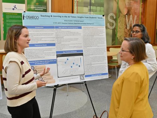 Senior human development major Krista Souders presents her research poster “Teaching and Learning in the AI Times: Insights From Students’ Voices” at the university’s Fall Poster Symposium to Kristin Croyle 