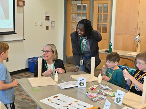 Leaders from National Grid and SUNY Oswego join children in a previous KidsTech session