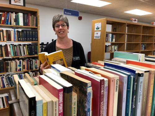 Sarah Weisman looks at books for Penfield Library book sale