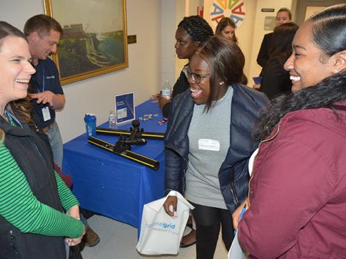 Holly Oyer, National Grid director of gas field operations in Central New York, talks with SUNY Oswego students Taylor Clark and Kariya Buckshot
