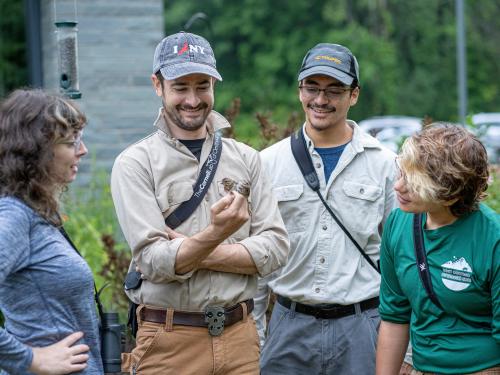 Ornithology research at Rice Creek Field Station by biological sciences faculty member Daniel Baldassare (second from left, with birds) and students, from left, Brooke Goodman, Denis Ramos and Shyla Luna.