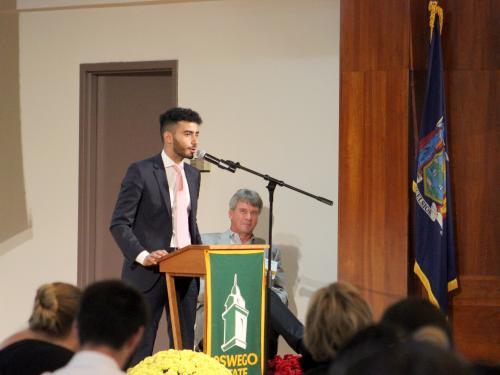 Ahmed Albajari, at podium, was selected to speak on behalf of all scholarship students at the annual SUNY Oswego Scholars Breakfast