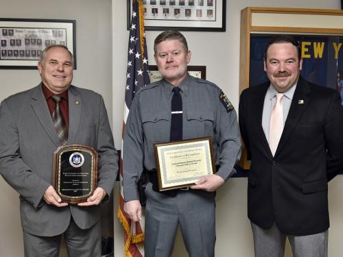 University Police Technical Sergeant Richard Sherwood was named recipient of a 2021 SUNY University Police Professional Service Award. Sherwood, center, is congratulated by University Police Chief Kevin Velzy, left, and Assistant Chief Scott Swayze