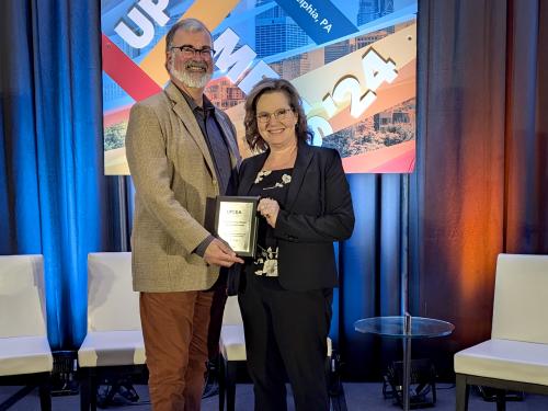 SUNY Oswego staff members accept UPCEA award