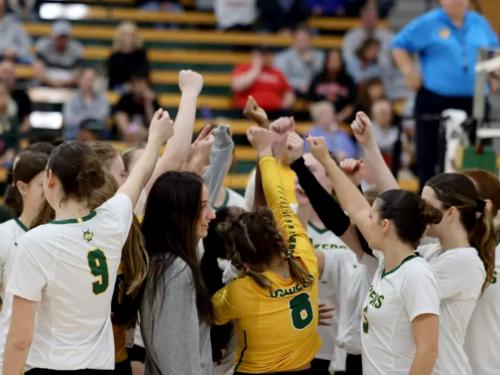 Women's volleyball team huddles up