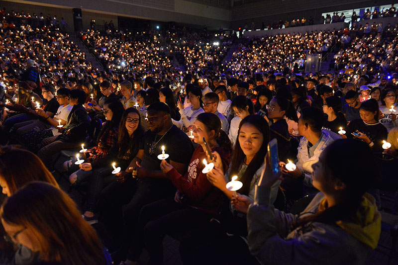 Students holding candles at Torchlight