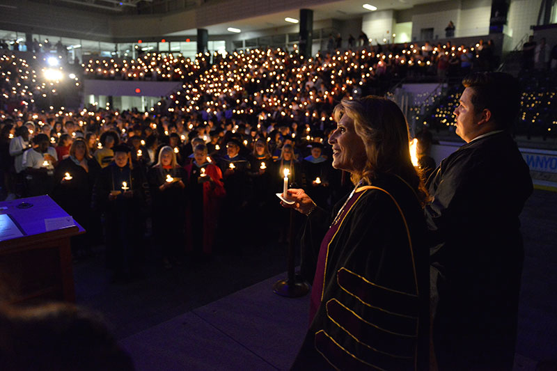 President Deborah F. Stanley and students enter arena