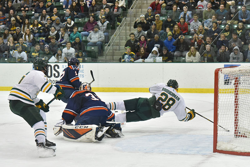 Laker freshman forward Travis Broughman launches toward the puck in a men's hockey game