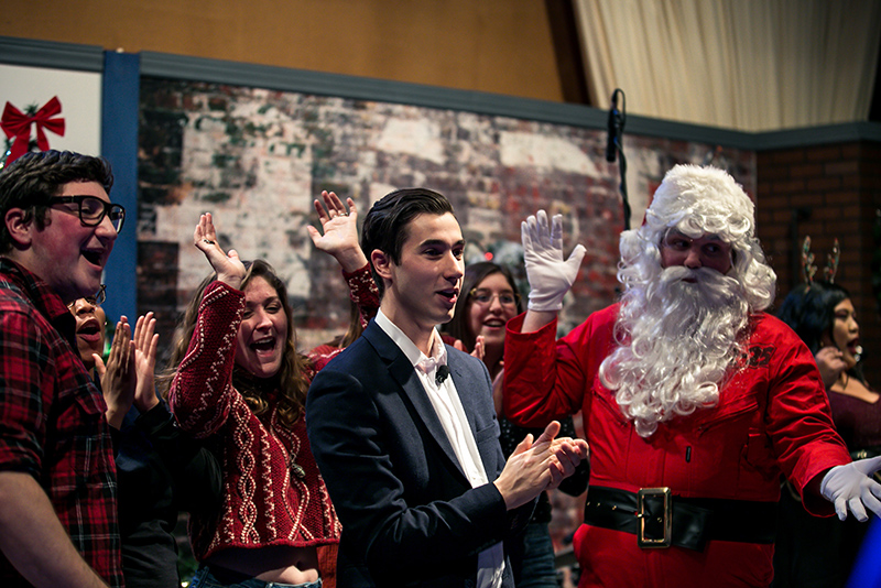 Student host David Hite (center) and an eclectic cast of characters celebrate wrapping up filming the upcoming Oswego Holiday TV Special