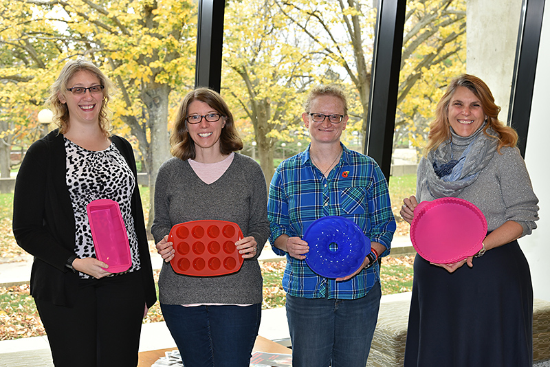 Holding some of the new silicone bakeware as winners from the three State Employees Federated Appeal Bake Offs are, from left, Jenny Grass, EXCEL office; political science faculty members Allison Rank and Helen Knowles; and Angela Galvin, Office of the Vice President for Administration and Financ