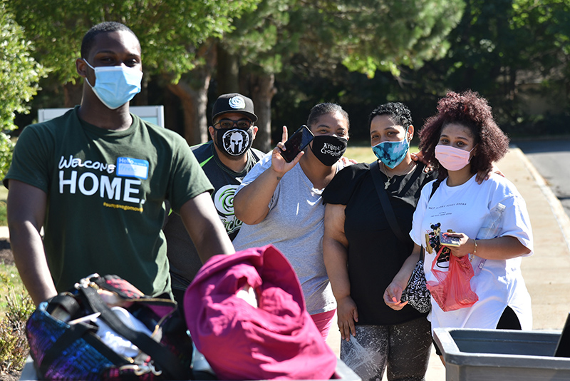 Roxana Dolores (right), a freshman criminal justice major, moves into Johnson Hall Aug. 14 escorted by her enthusiastic family members