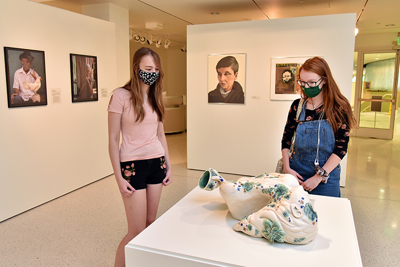 Looking at a ceramic sculpture titled "Holding Tight, Letting Go," which is a 2011 Presidential Purchase Award by artist and former SUNY Oswego student Caroline Hayward, are Ellen Weber (left), a junior graphic design major and art gallery attendant, and Megan Campbell, a senior theatre major